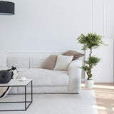 Green artificial plant ACACIA in a white pot next to a sofa by hjh OFFICE