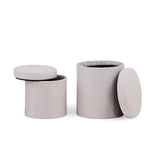 Two cylindrical Nestup 1 side tables with removable padded lids in a light grey tone by hjh LIVING