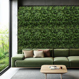 Green plant mat LEAFLUXE 2 as vertical greenery on a wall behind a sofa by hjh LIVING