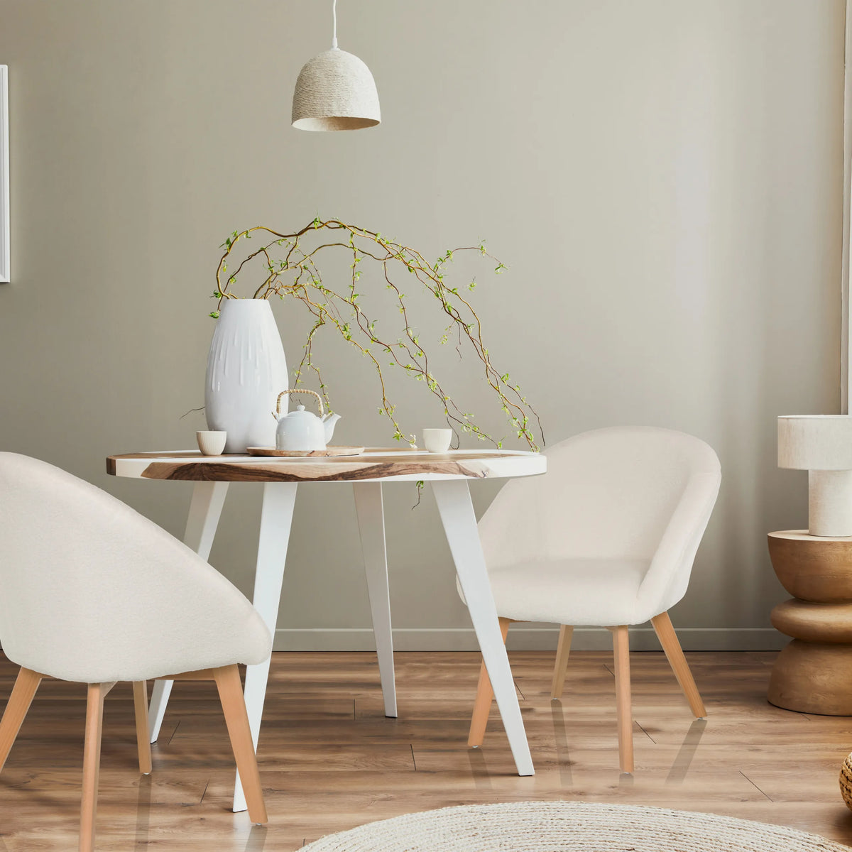 Two white upholstered chairs SCANDI TED with light wood legs at a round table by hjh LIVING