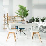 Green artificial plant ARECA in a light grey outer pot on a white desk by hjh OFFICE