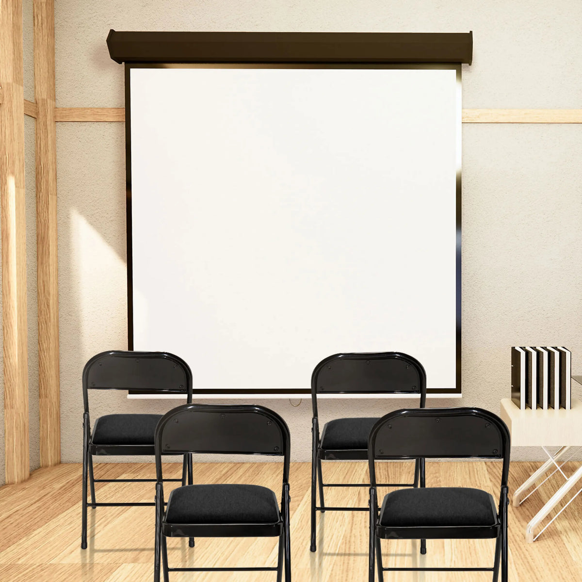 Four black TUDELA II folding chairs with fabric covers in front of a white screen by hjh OFFICE