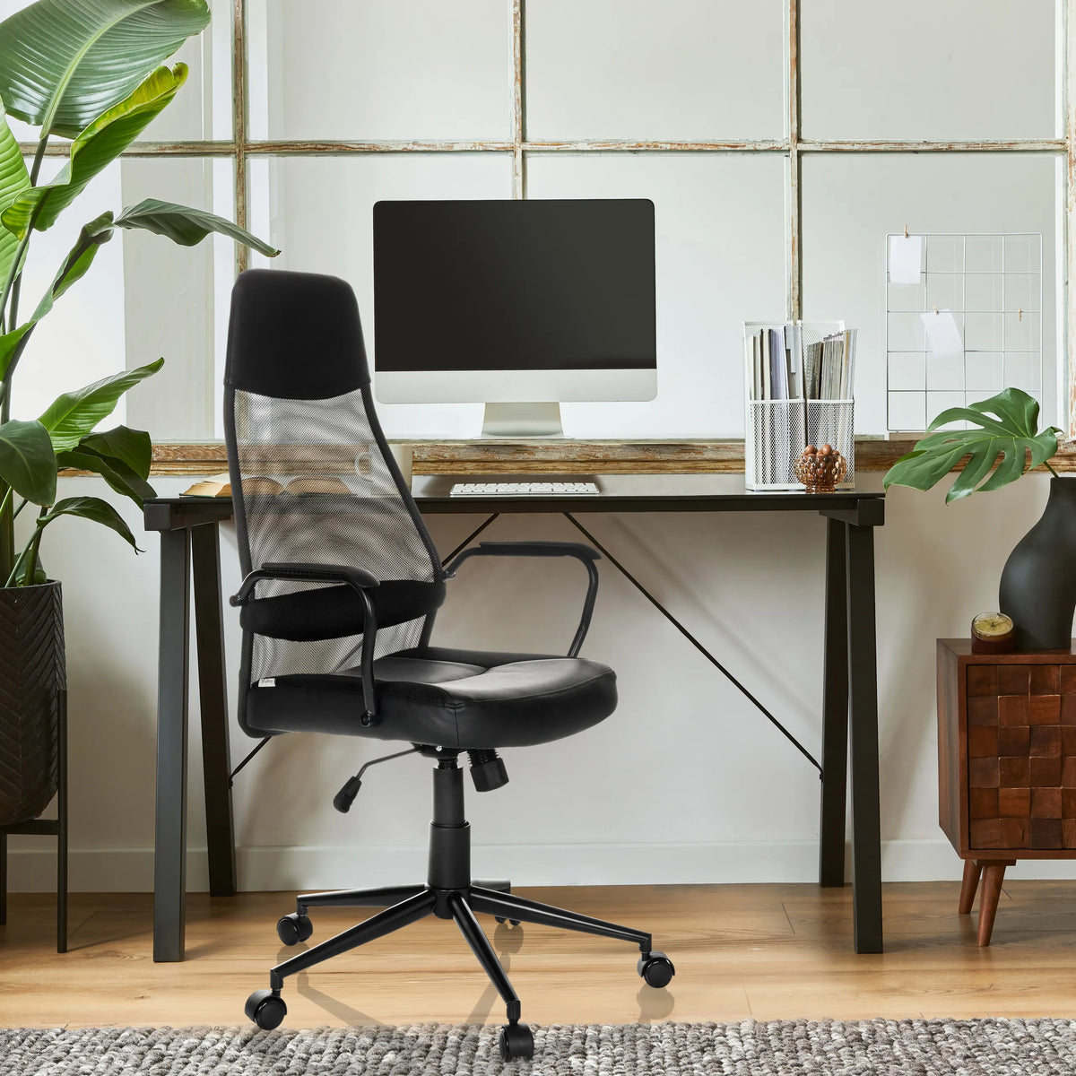 Black MARCOZ Home Office Executive Chair with mesh backrest and armrests in front of a desk by MyBuero