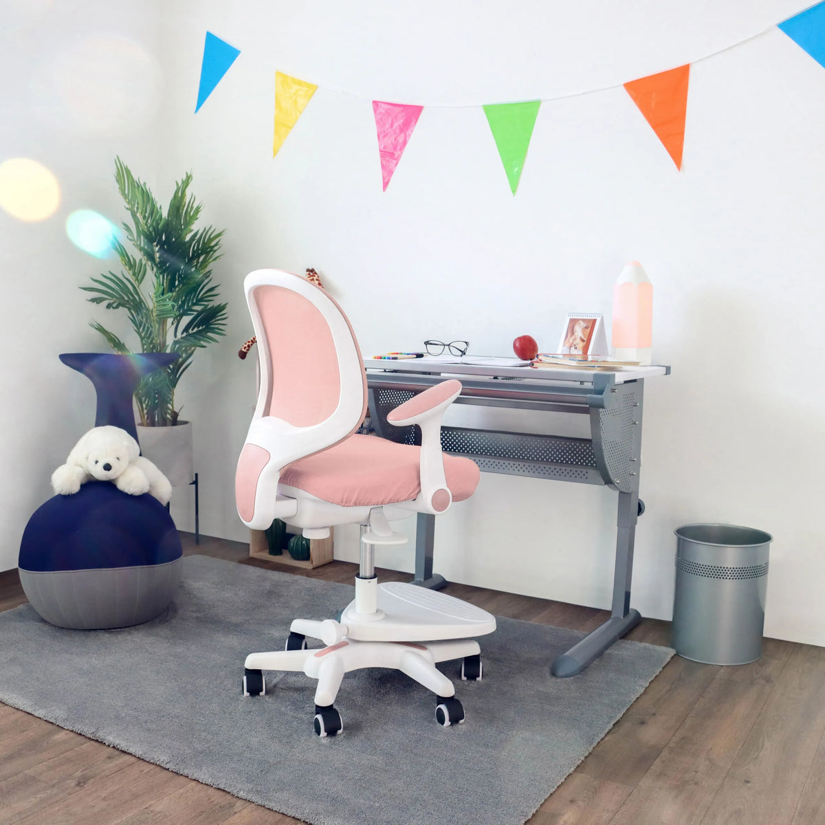 Pink children's chair KID ERGO with white armrests and castors at a desk by hjh OFFICE