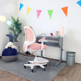 Pink children's chair KID ERGO with white armrests and castors at a desk by hjh OFFICE