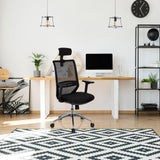 Black Professional Office Chair PROFONDO PRO with mesh backrest and headrest in front of a desk by hjh OFFICE