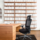 Black High End Office Chair NOVA PRO I with headrest and mesh back in front of a wooden desk by hjh OFFICE
