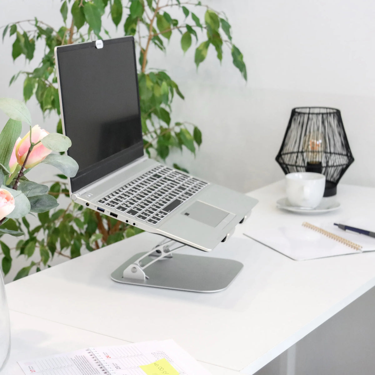 Silver Pad LAPTOP STAND with adjustable stand on a white desk by hjh OFFICE