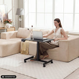 Black Stand K standing desk with a laptop on a light-coloured sofa by hjh OFFICE (AI-generated image)