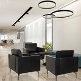 Three black BAVERO Lounge Chairs made of faux leather in a modern office lounge by hjh OFFICE