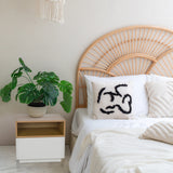 White side table MELMO with open shelf in oak effect next to a bed by hjh LIVING