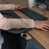 Black RELEX RT2 armrest on a desk with keyboard and mouse by hjh OFFICE