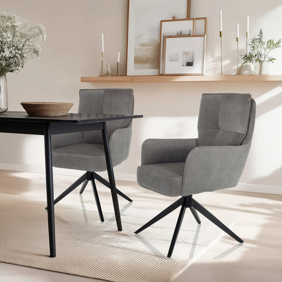 Two grey upholstered chairs TARUGO with black star bases at a black table by hjh LIVING