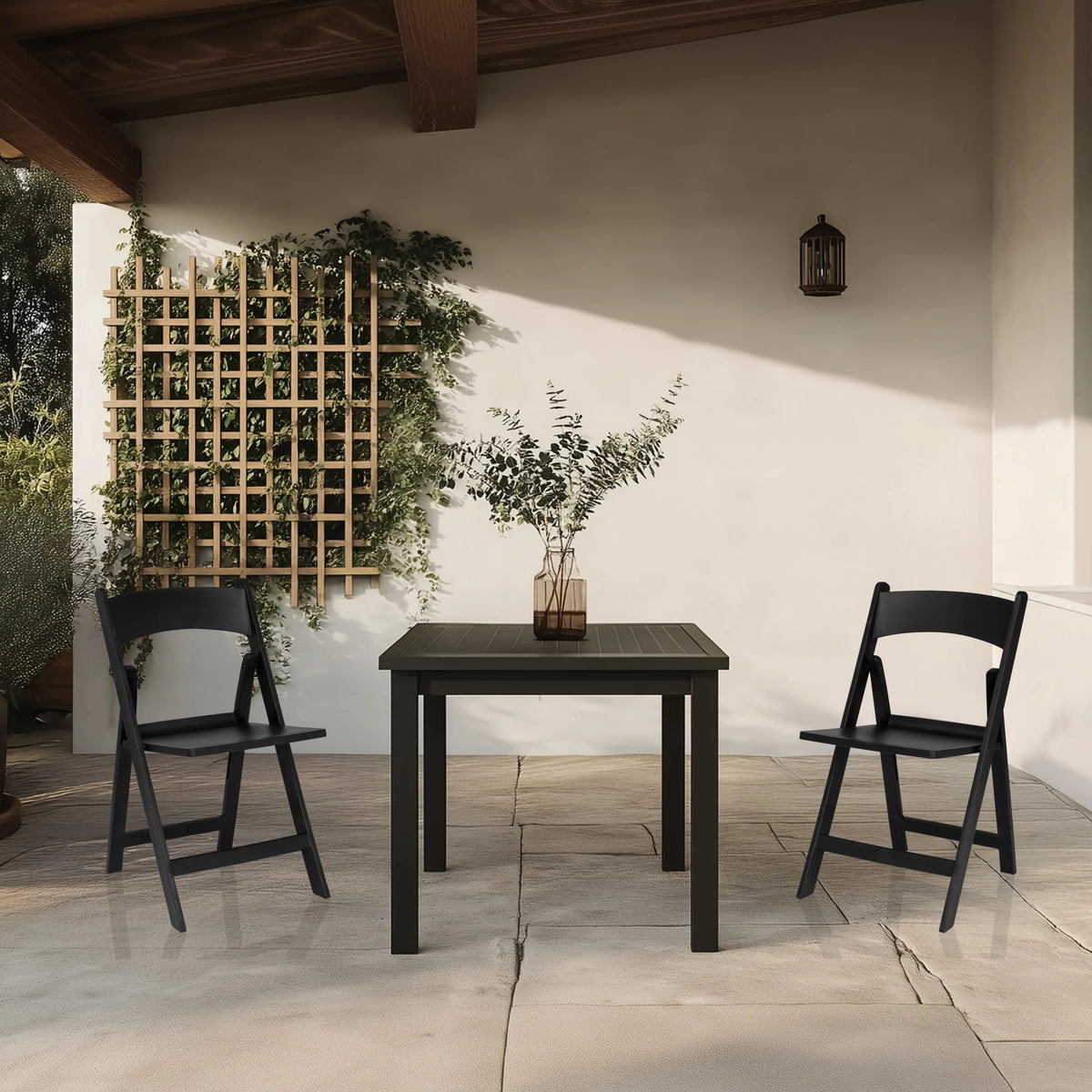 Two black TRAVANO 1 outdoor chairs with matching table on a terrace by hjh LIVING