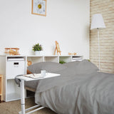 White standing desk STAND II with a notebook and a cup on the tabletop by hjh OFFICE
