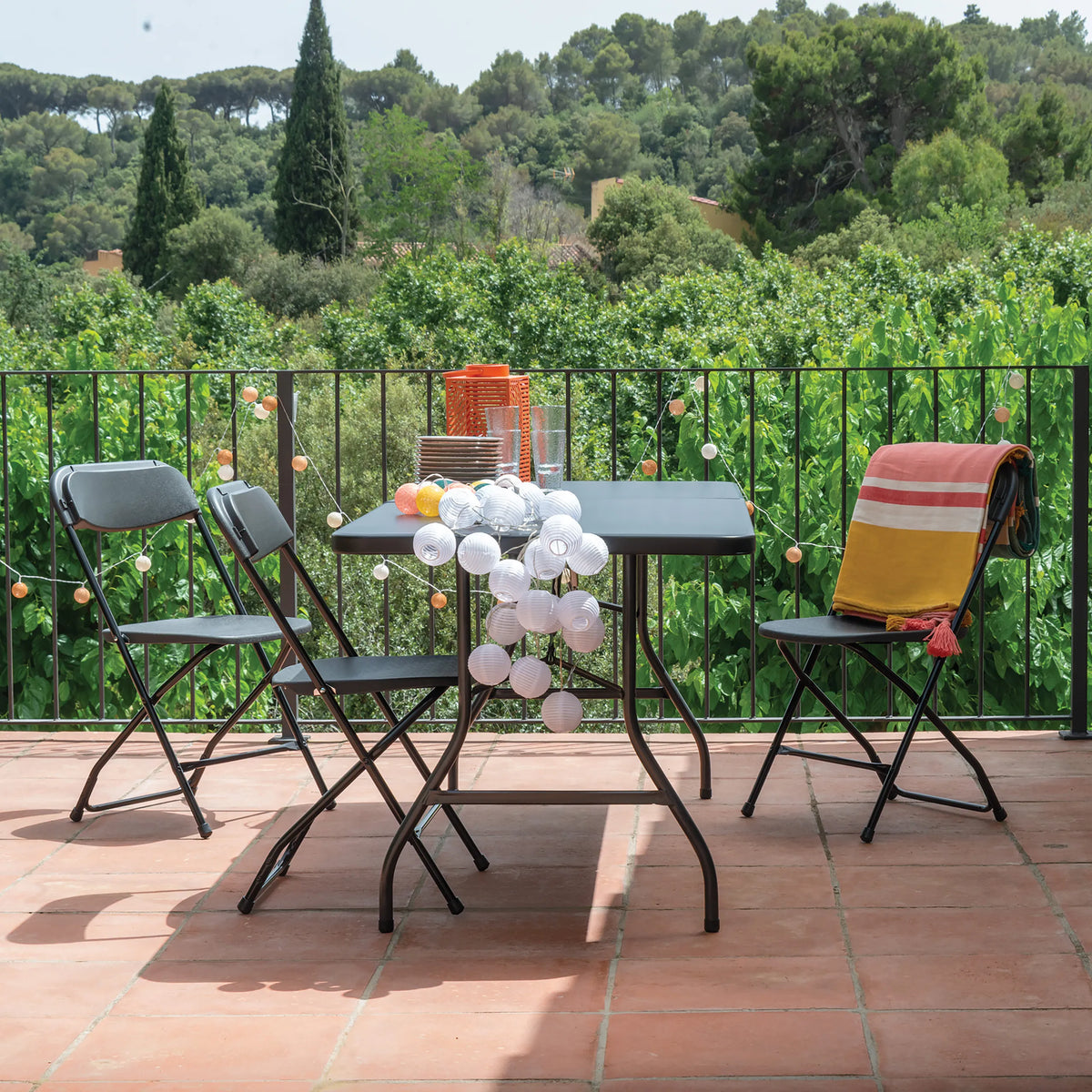 Three black TUDELA XXL B outdoor chairs with a square table on a terrace by hjh OFFICE