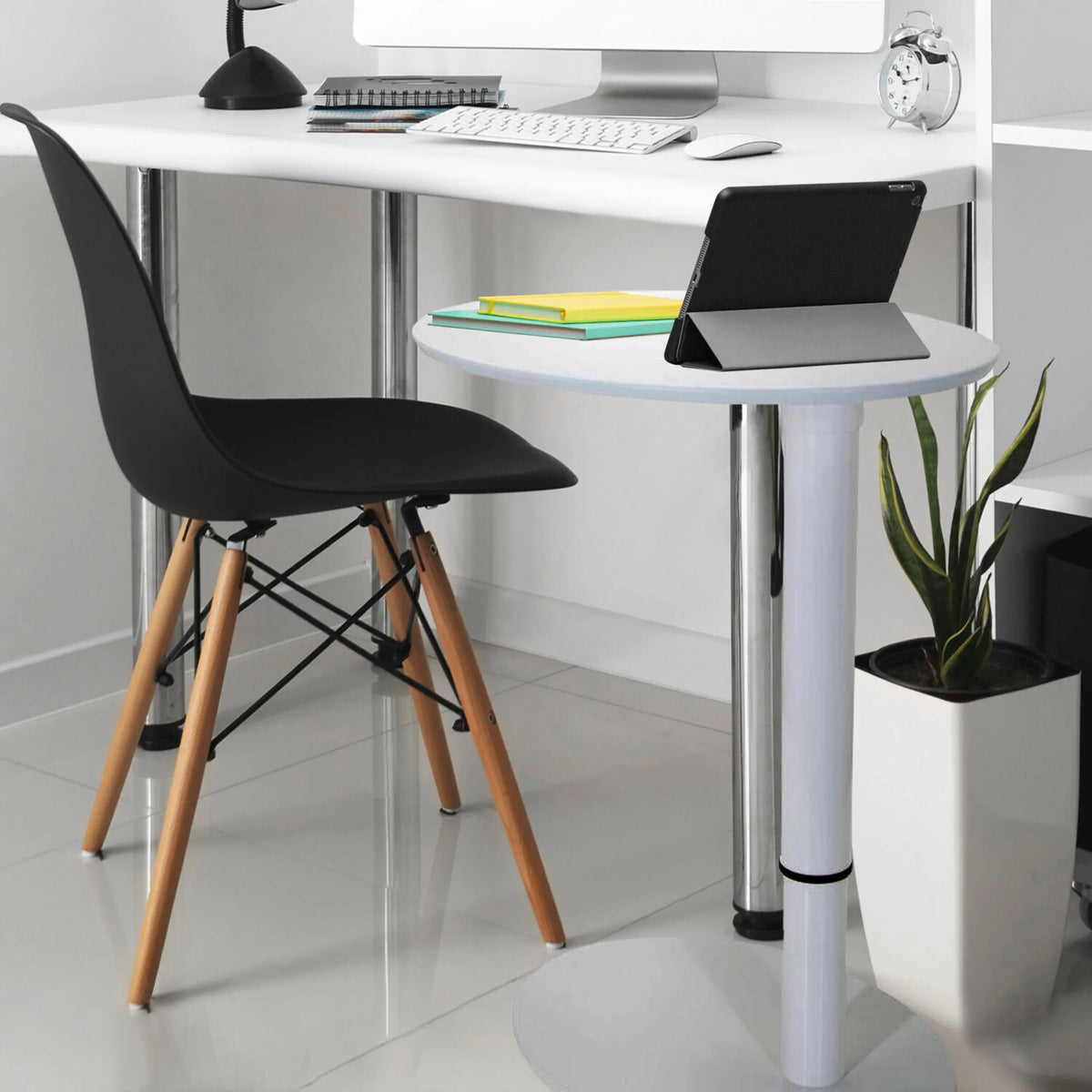 White standing desk STAND III with a round storage surface, black chair and a houseplant by hjh OFFICE