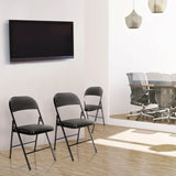 Three black TUDELA folding chairs with faux leather upholstery in a room by hjh OFFICE