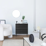 Black KARBY K chest of drawers with three drawers and slim metal feet in a bright living room by hjh LIVING