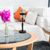 Black mobile phone & tablet holder FLEXMOBI II with smartphone on a glass table in front of a white sofa by hjh OFFICE