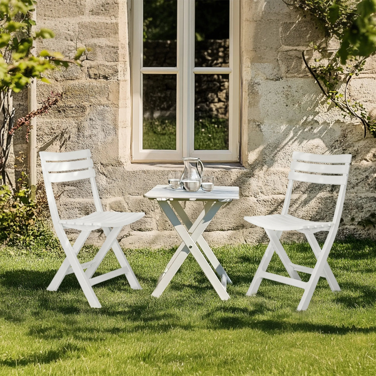 Two white Outdoor chairs TRAVANO with matching folding table on a lawn by hjh LIVING