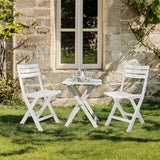 Two white Outdoor chairs TRAVANO with matching folding table on a lawn by hjh LIVING