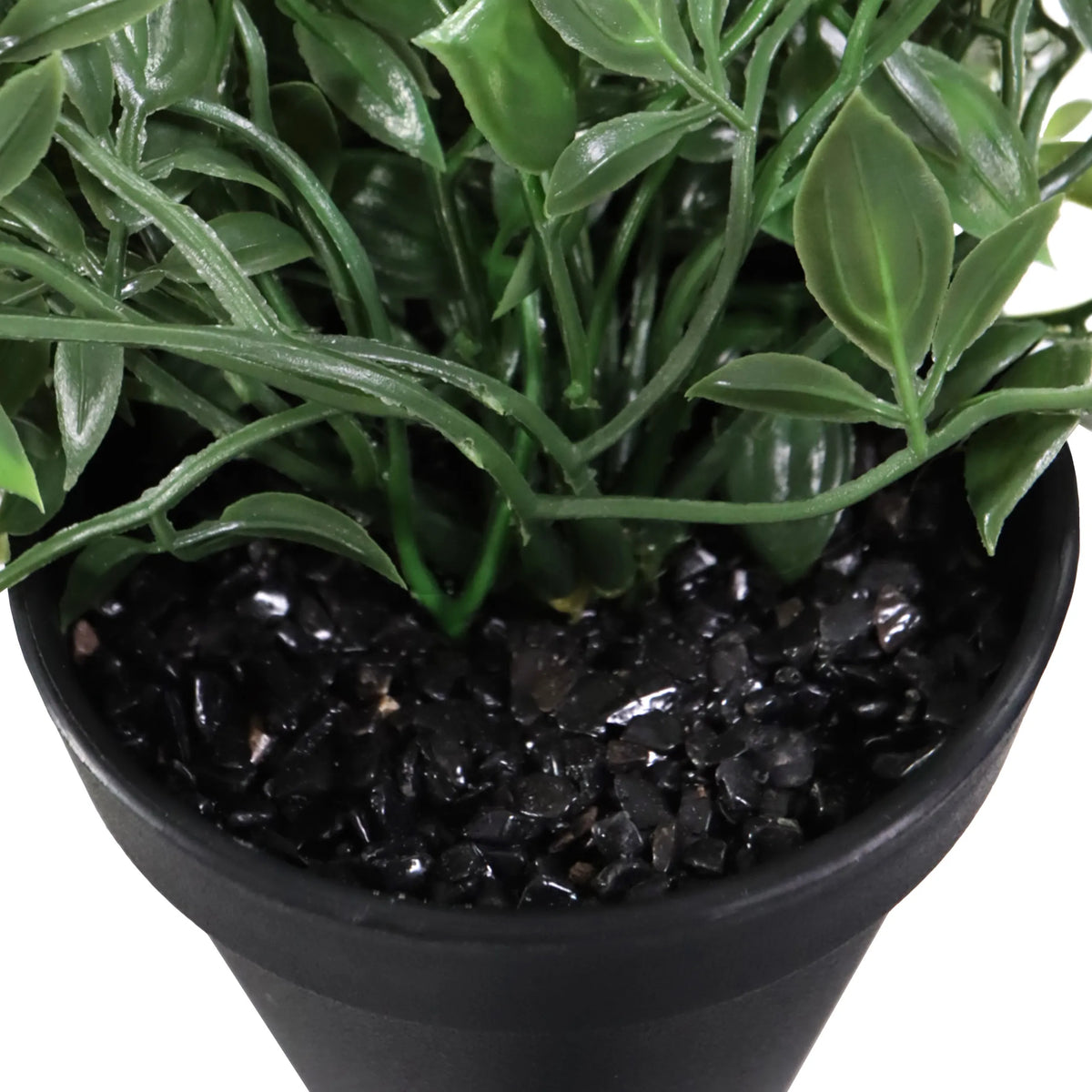 Green leaves and black decorative stones of the Epipremnum Climb artificial plant in a black pot by hjh OFFICE