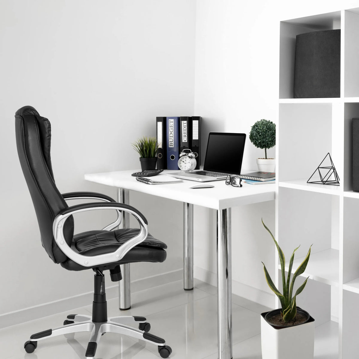 Black RELAX WB100 gaming chair at a white desk in a bright office by MyBuero