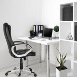 Black RELAX WB100 gaming chair at a white desk in a bright office by MyBuero