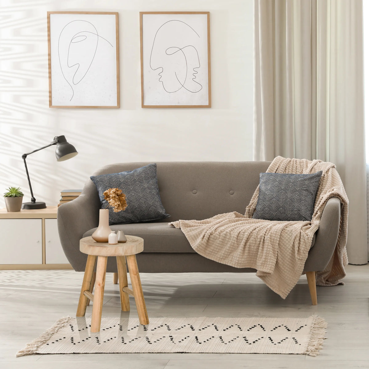 Brown wooden RUSTIKO W stool used as a side table in front of a grey sofa by hjh LIVING