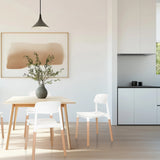 Four-legged chair SCANDI E in white with light wood legs in a dining area by hjh LIVING